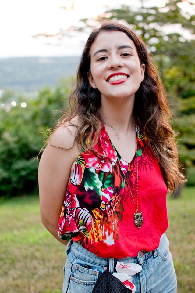 Photograph of a girl with a red shirt smiling